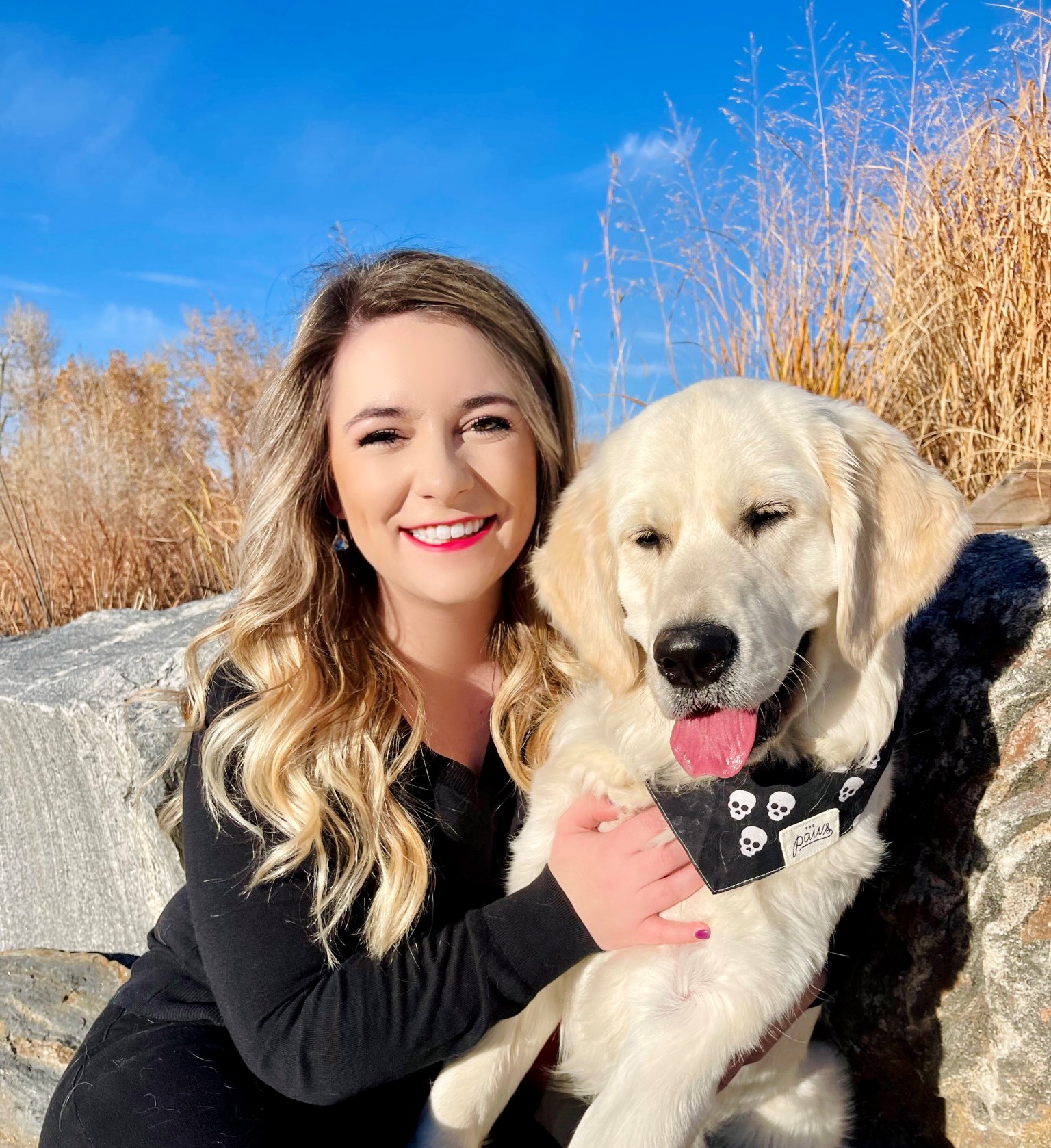 Female professional in black clothing with dog